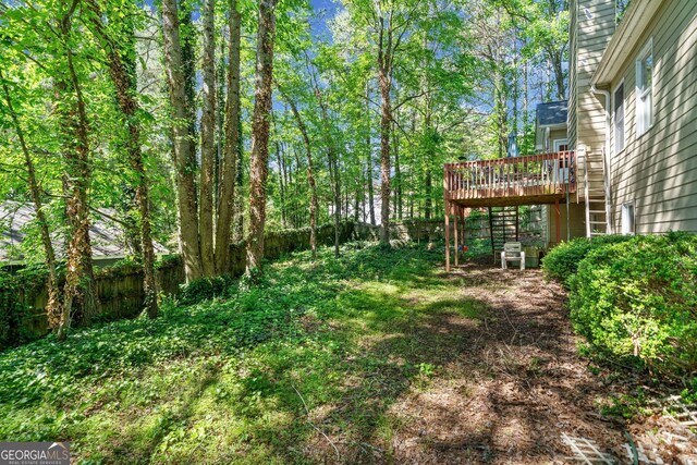 614 Springharbor Dr, Woodstock, GA 30188 - fenced backyard with a wooden deck and stairs