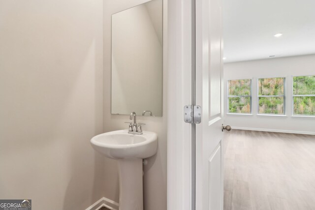 2762 Aralynn Way, College Park, GA 30337 - bathroom featuring a sink, wood finished floors, baseboards, and recessed lighting