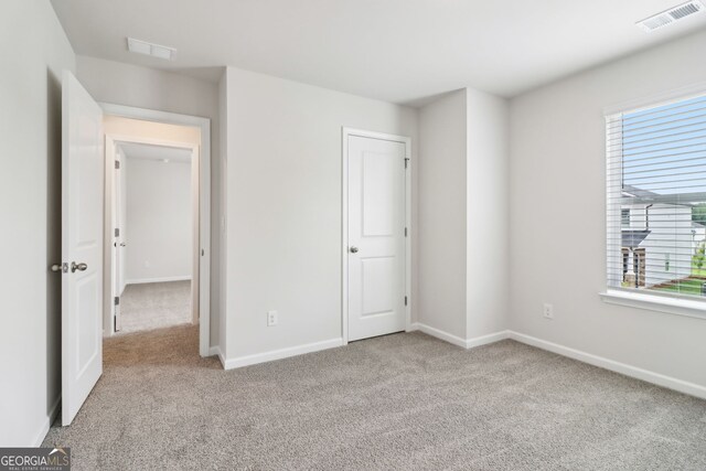 2762 Aralynn Way, College Park, GA 30337 - unfurnished bedroom with carpet flooring, visible vents, and multiple windows