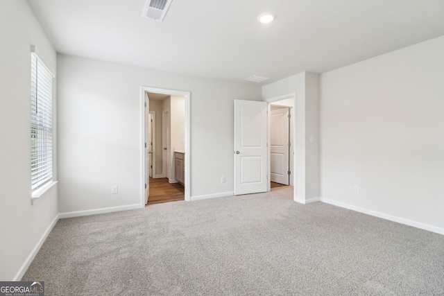 2762 Aralynn Way, College Park, GA 30337 - unfurnished bedroom with carpet flooring, baseboards, visible vents, and multiple windows