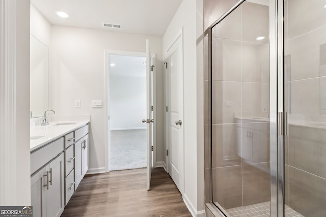 2762 Aralynn Way, College Park, GA 30337 - full bathroom with visible vents, wood finished floors, a shower stall, and a sink