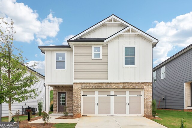 2764 Aralynn Way, College Park, GA 30337 - view of front of home with driveway, brick siding, an attached garage, and a front yard