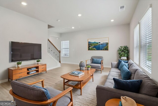 2764 Aralynn Way, College Park, GA 30337 - living room featuring stairway, visible vents, plenty of natural light, and wood finished floors