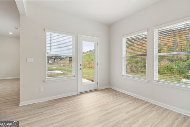 2764 Aralynn Way, College Park, GA 30337 - doorway with light wood finished floors, plenty of natural light, visible vents, and baseboards