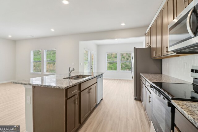 2764 Aralynn Way, College Park, GA 30337 - kitchen featuring light wood-type flooring, a kitchen island with sink, appliances with stainless steel finishes, and a sink