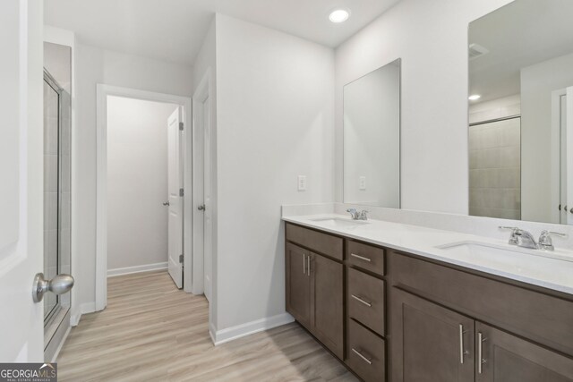 2764 Aralynn Way, College Park, GA 30337 - full bathroom with baseboards, double vanity, a sink, and wood finished floors