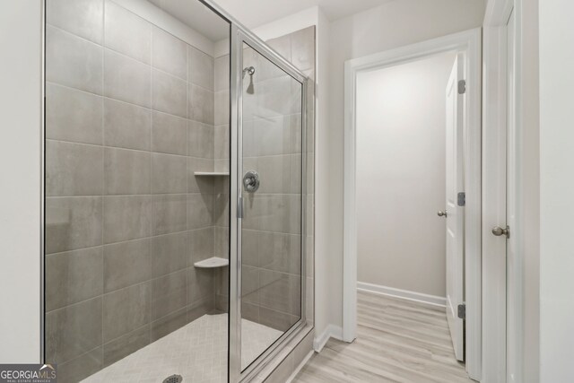 2764 Aralynn Way, College Park, GA 30337 - bathroom with a stall shower, baseboards, and wood finished floors