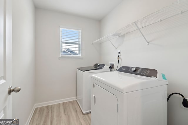 2764 Aralynn Way, College Park, GA 30337 - laundry area featuring laundry area, light wood-style flooring, baseboards, and washing machine and clothes dryer