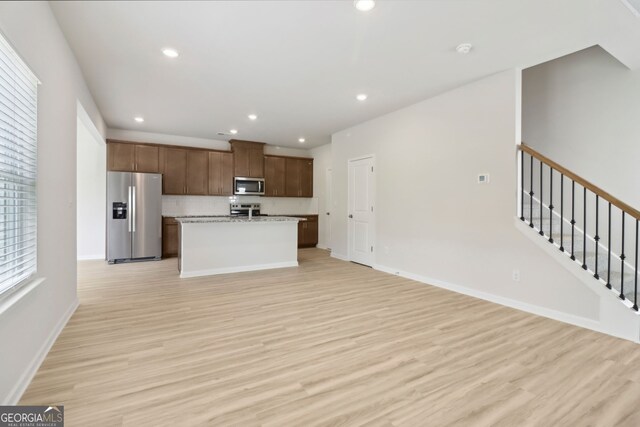 2764 Aralynn Way, College Park, GA 30337 - kitchen featuring light wood-type flooring, recessed lighting, a center island with sink, open floor plan, and appliances with stainless steel finishes