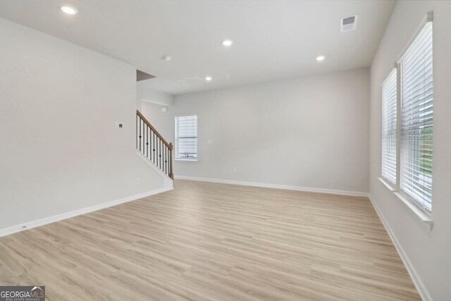 2764 Aralynn Way, College Park, GA 30337 - unfurnished living room featuring recessed lighting, baseboards, visible vents, stairway, and light wood-type flooring