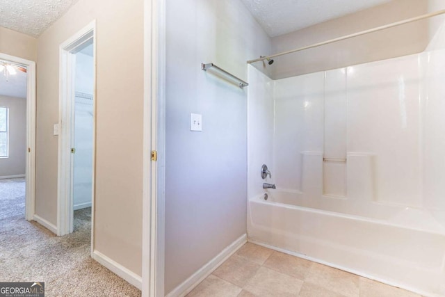 805 Old Rocky Rd, Atlanta, GA 30349 - full bathroom with baseboards, bathtub / shower combination, and a textured ceiling
