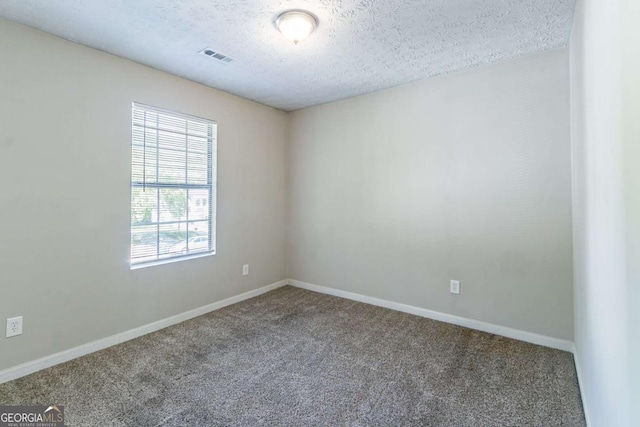 805 Old Rocky Rd, Atlanta, GA 30349 - spare room featuring baseboards, carpet flooring, and a textured ceiling