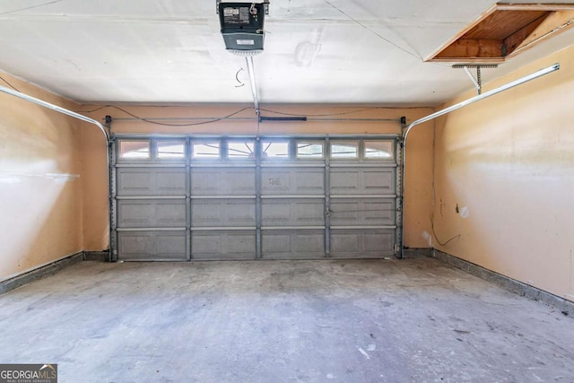 805 Old Rocky Rd, Atlanta, GA 30349 - garage featuring baseboards and a garage door opener