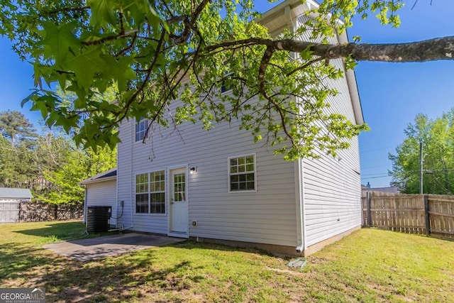 805 Old Rocky Rd, Atlanta, GA 30349 - rear view of property with fence, a lawn, a patio area, and central AC unit