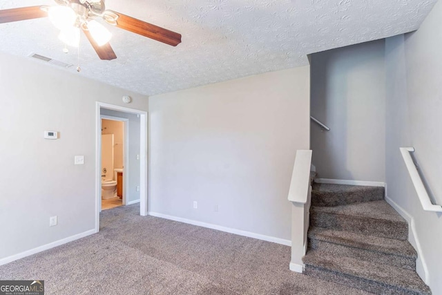 805 Old Rocky Rd, Atlanta, GA 30349 - staircase with carpet flooring, a textured ceiling, baseboards, visible vents, and ceiling fan