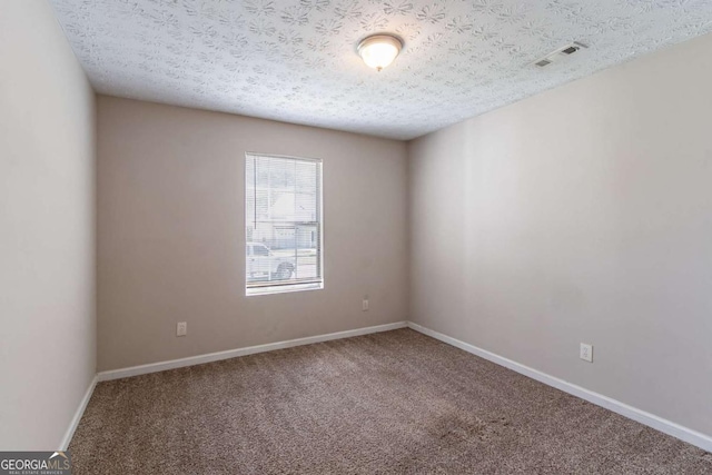 805 Old Rocky Rd, Atlanta, GA 30349 - carpeted spare room featuring baseboards, visible vents, and a textured ceiling