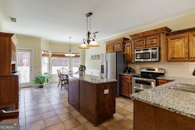 kitchen with an inviting chandelier, appliances with stainless steel finishes, a sink, a center island, and visible vents