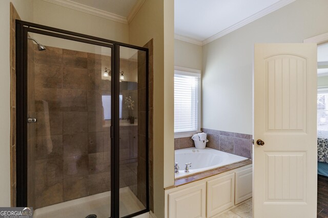 ensuite bathroom with ensuite bathroom, a bath, a stall shower, and ornamental molding