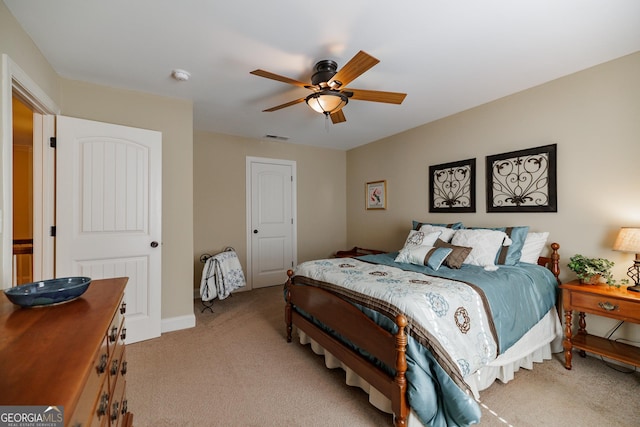 bedroom featuring visible vents, ceiling fan, and light colored carpet