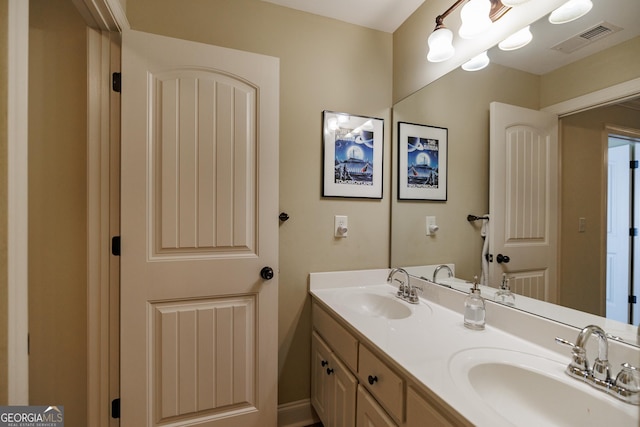 full bathroom featuring a sink, double vanity, and visible vents