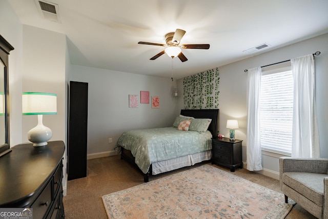 bedroom with visible vents, baseboards, and light carpet