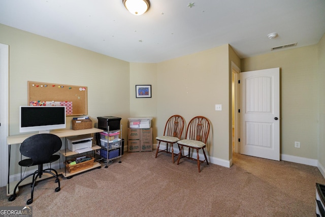 carpeted office with baseboards and visible vents