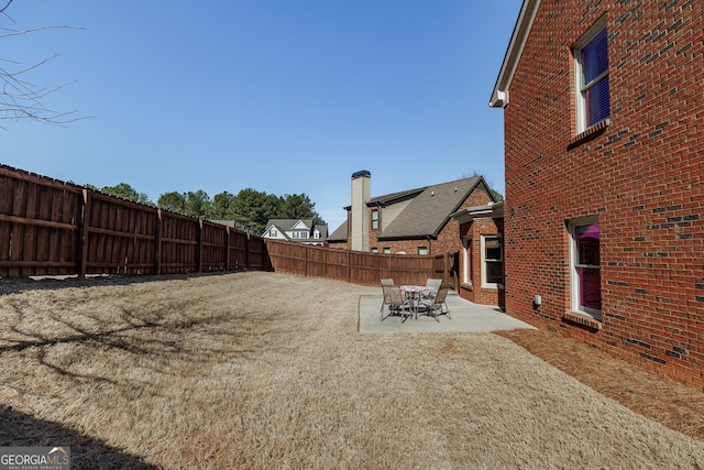 view of yard featuring a fenced backyard and a patio area