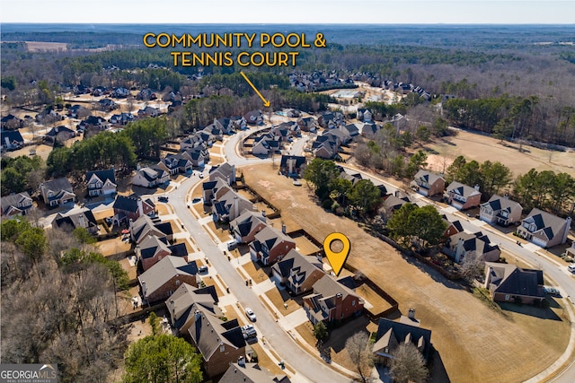 aerial view featuring a wooded view and a residential view