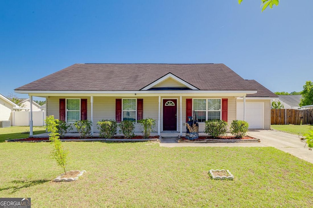 208 Kelly Ave, Rincon, GA 31326 - view of front facade with fence, an attached garage, covered porch, and concrete driveway