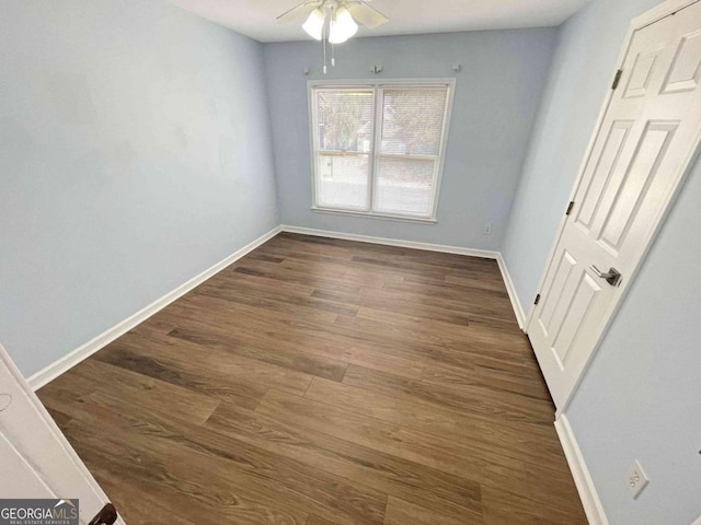 unfurnished dining area with baseboards, dark wood-style floors, and ceiling fan