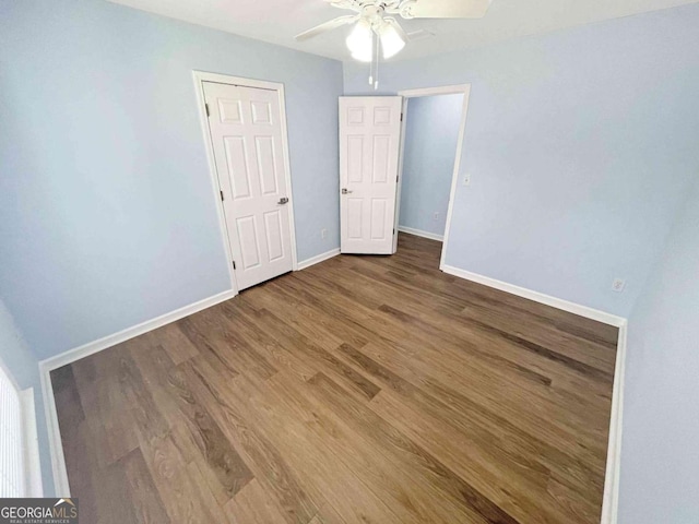 unfurnished bedroom with baseboards, wood finished floors, and ceiling fan