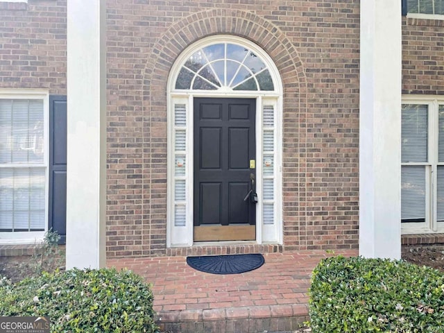 property entrance with brick siding
