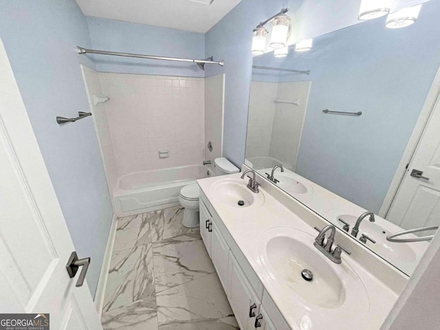 full bathroom featuring marble finish floor, toilet, and a sink