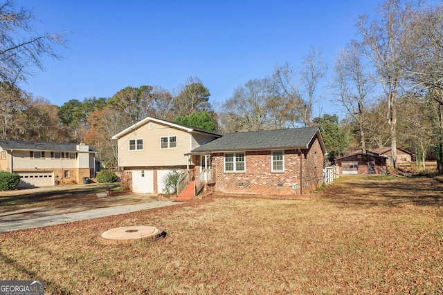split level home with crawl space, driveway, a garage, brick siding, and roof with shingles
