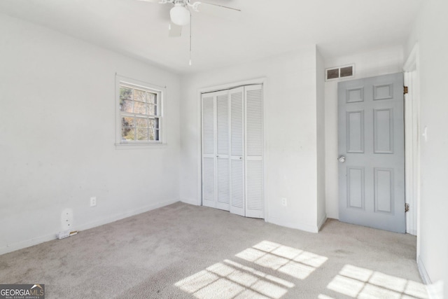unfurnished bedroom with a closet, ceiling fan, baseboards, carpet flooring, and visible vents