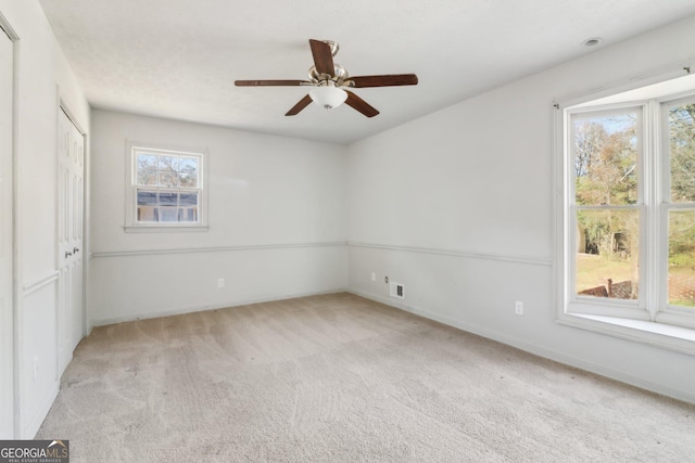 unfurnished bedroom featuring carpet, baseboards, and multiple windows
