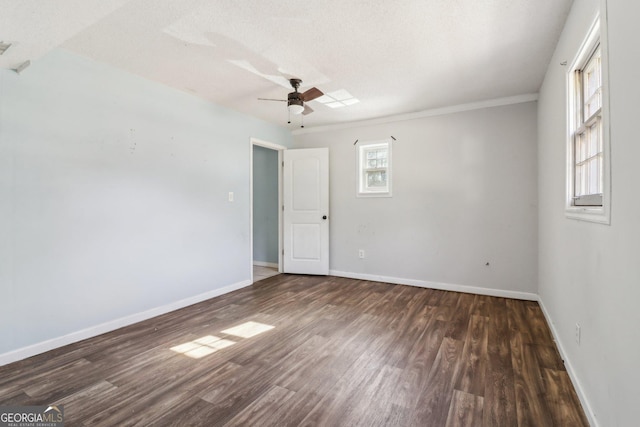 unfurnished room featuring wood finished floors, a ceiling fan, baseboards, and ornamental molding