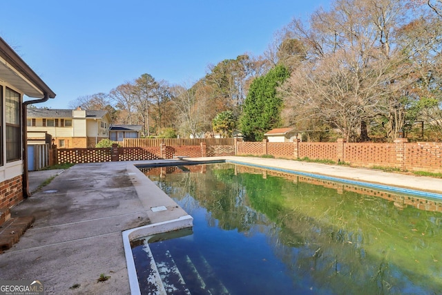 view of swimming pool featuring fence, a patio area, and a fenced in pool