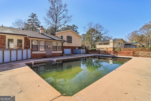 view of swimming pool featuring a fenced in pool, a patio, and fence
