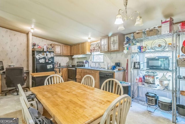 dining room featuring vaulted ceiling and wallpapered walls