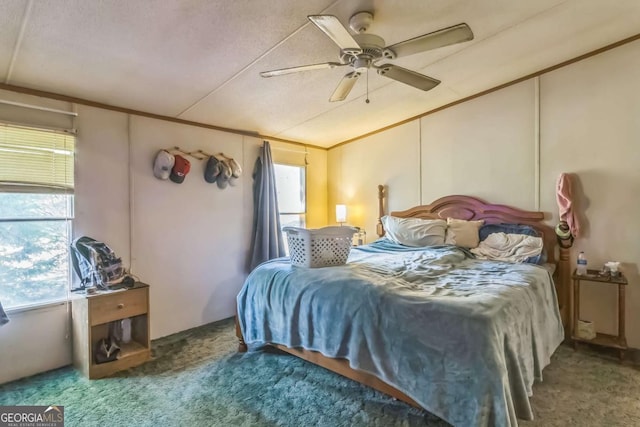 bedroom with vaulted ceiling, carpet floors, a ceiling fan, and multiple windows