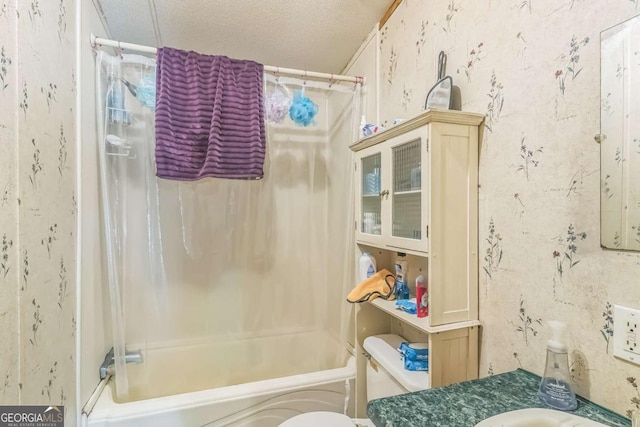 bathroom featuring shower / bath combination with curtain, toilet, vanity, and a textured ceiling