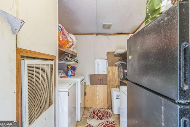 washroom featuring a textured ceiling, a heating unit, visible vents, independent washer and dryer, and laundry area