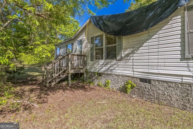view of side of property with crawl space