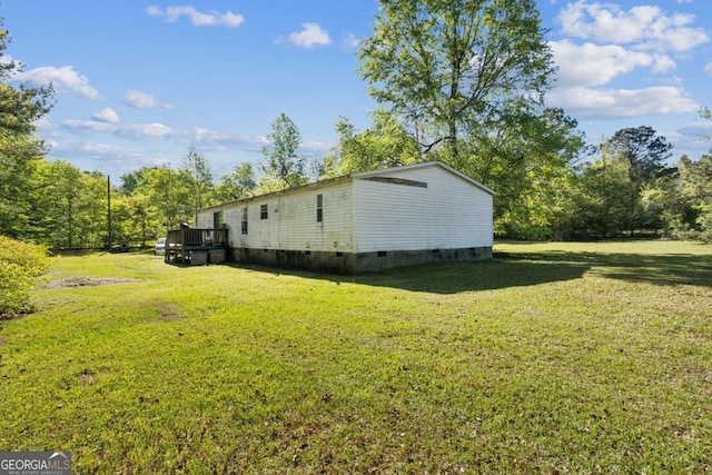 exterior space featuring a wooden deck, a yard, and crawl space