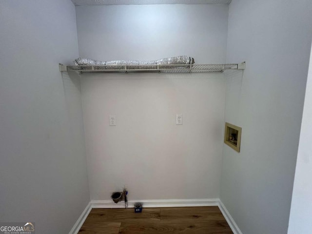 laundry room with baseboards, wood finished floors, laundry area, and washer hookup