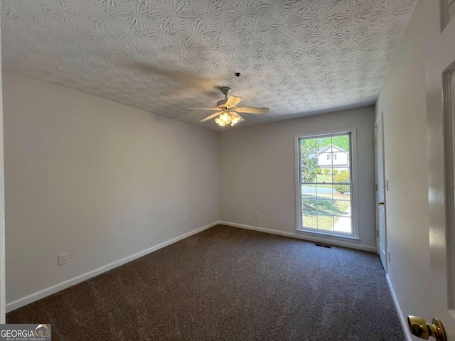 carpeted empty room featuring baseboards, a ceiling fan, a textured ceiling, and visible vents