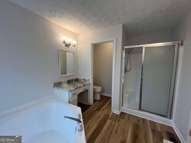 3861 Spring Meadow Dr, Acworth, GA 30101 - full bathroom with a stall shower, wood finished floors, vanity, a textured ceiling, and a garden tub