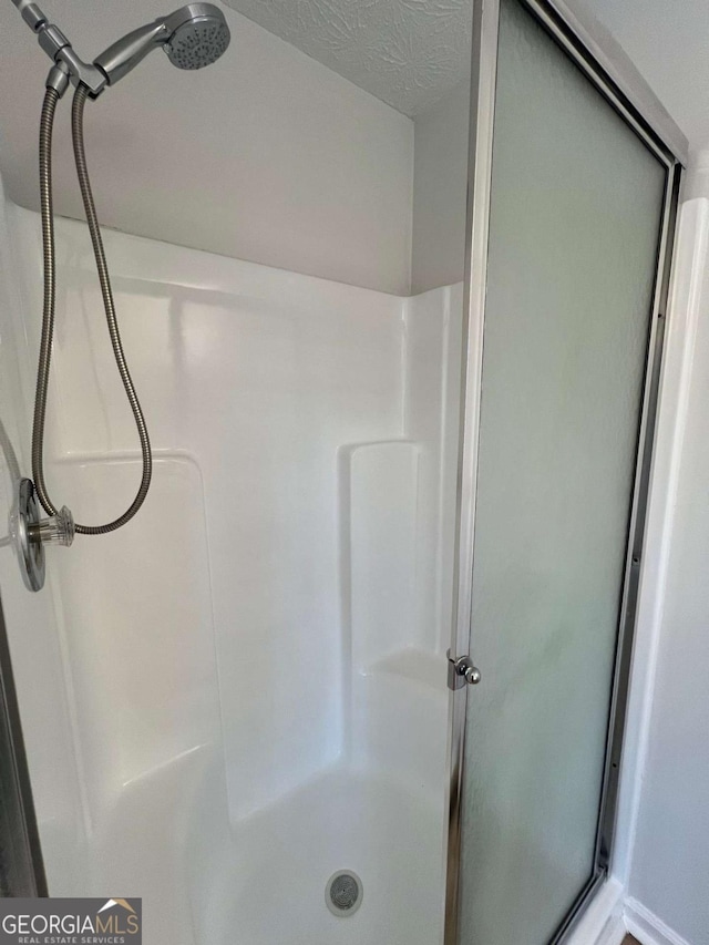 full bathroom featuring a shower stall