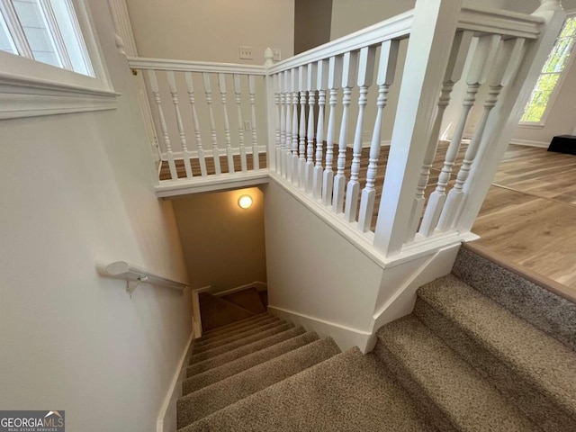 stairs with baseboards and a towering ceiling